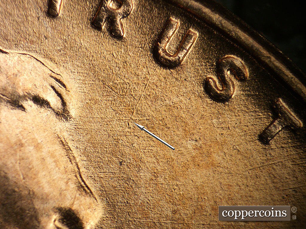 Die-stage A marker on 1952D•1MM•002 showing Unique die scratch from U in TRUST, E/W die scratches from forehead.