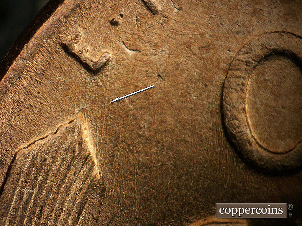 Die-stage A marker on 1952D•1MM•002 showing N/S die scratch from left wheat tip to dot in EPU.
