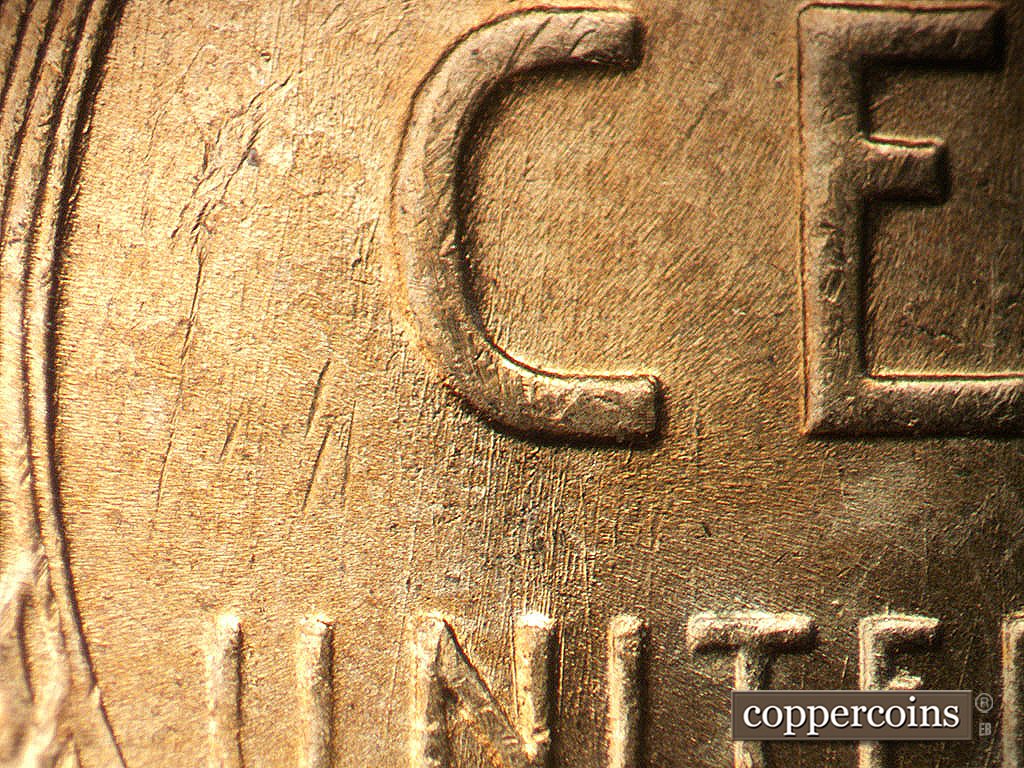 Die-stage A marker on 1952D•1MM•002 showing N/S die scratches from C in CENT to NI in UNITED.