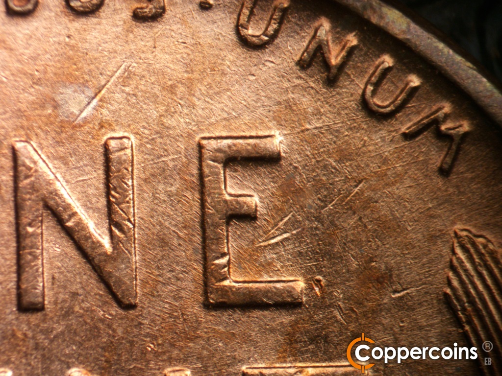 Die-stage C marker on 1952D•1MM•018 showing Crossing die scratches through and under UNUM.