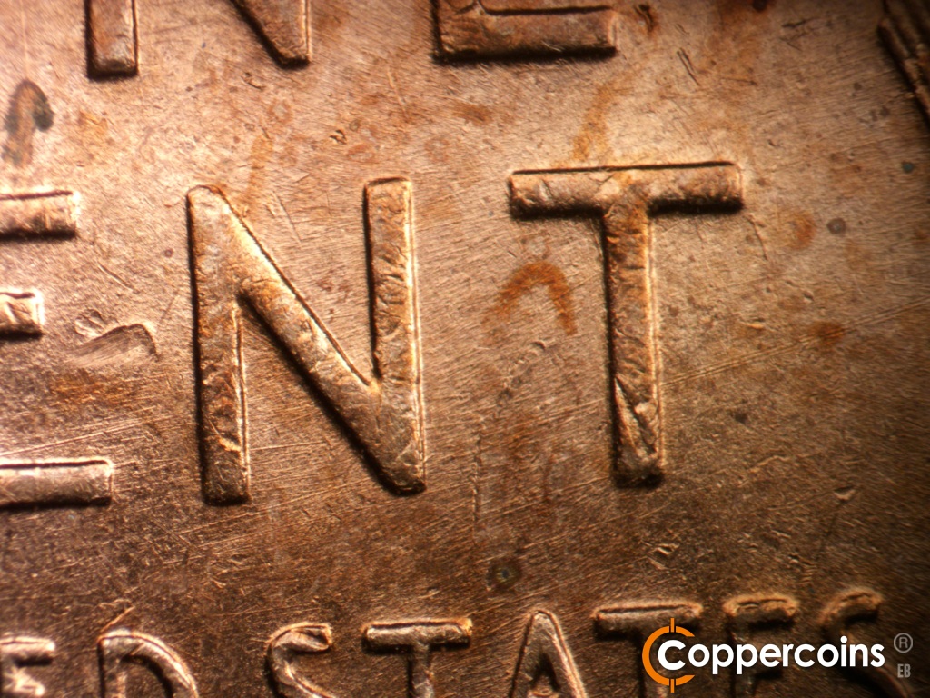 Die-stage C marker on 1952D•1MM•018 showing ENE die scratches through NT in CENT.