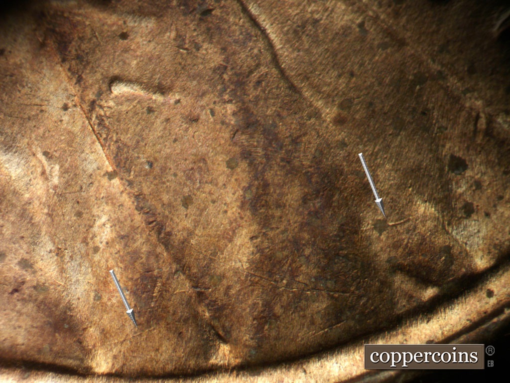 Die-stage B marker on 1952D•1MM•035 showing die crack along jacket into lapel.