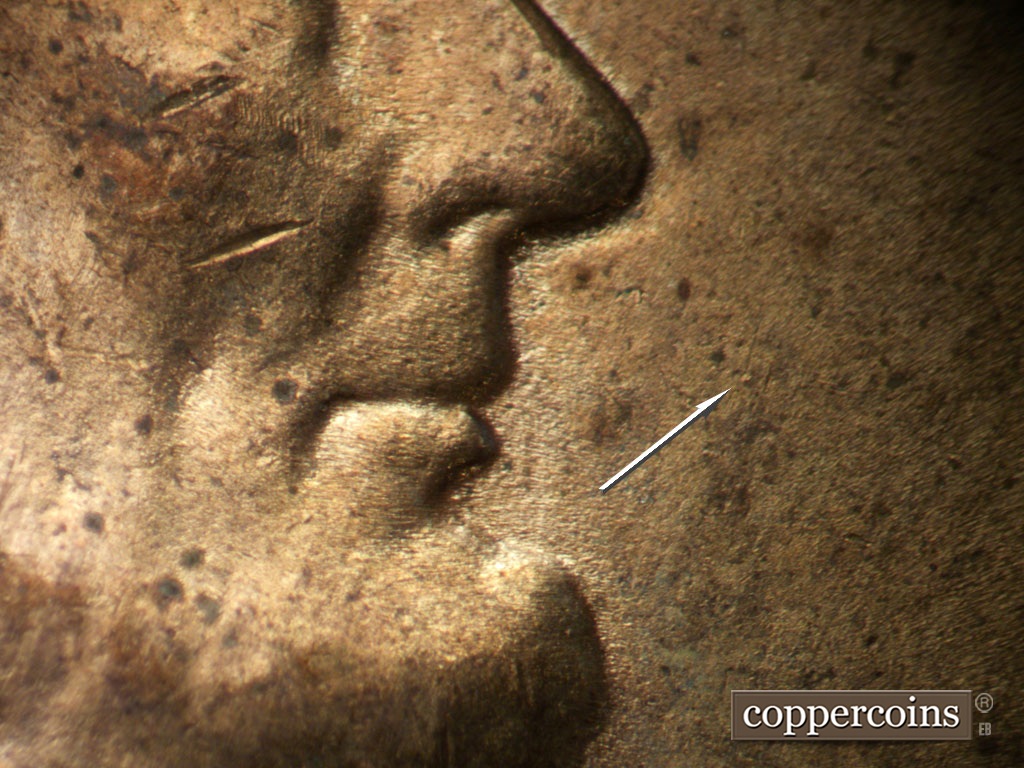 Die-stage B marker on 1952D•1MM•035 showing die dot east of mouth.