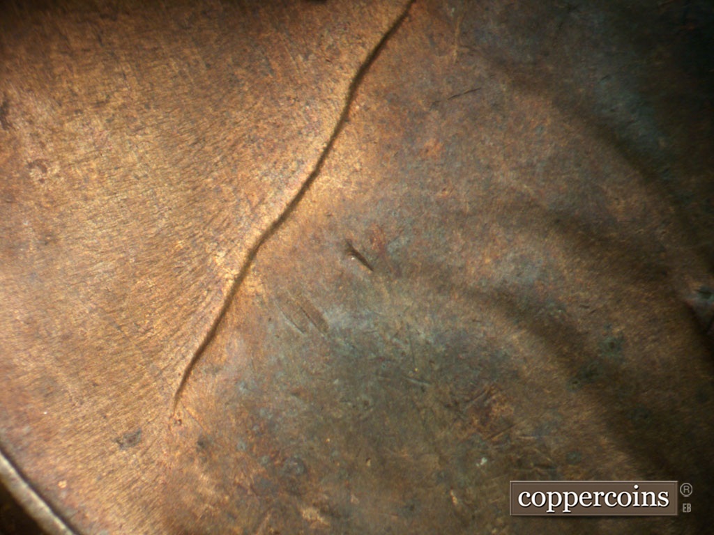 Die-stage C marker on 1952D•1MM•061 showing SE die scratches behind Back are almosr completely worn away.