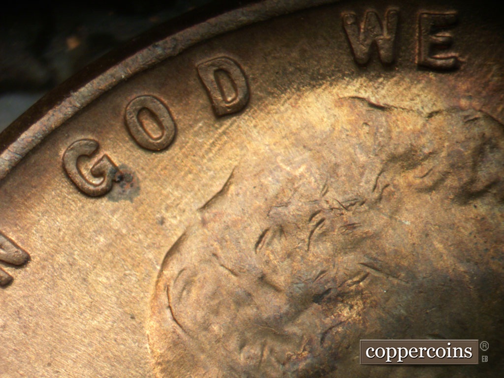 Die-stage C marker on 1952D•1MM•061 showing SE die scratches through and under GOD.