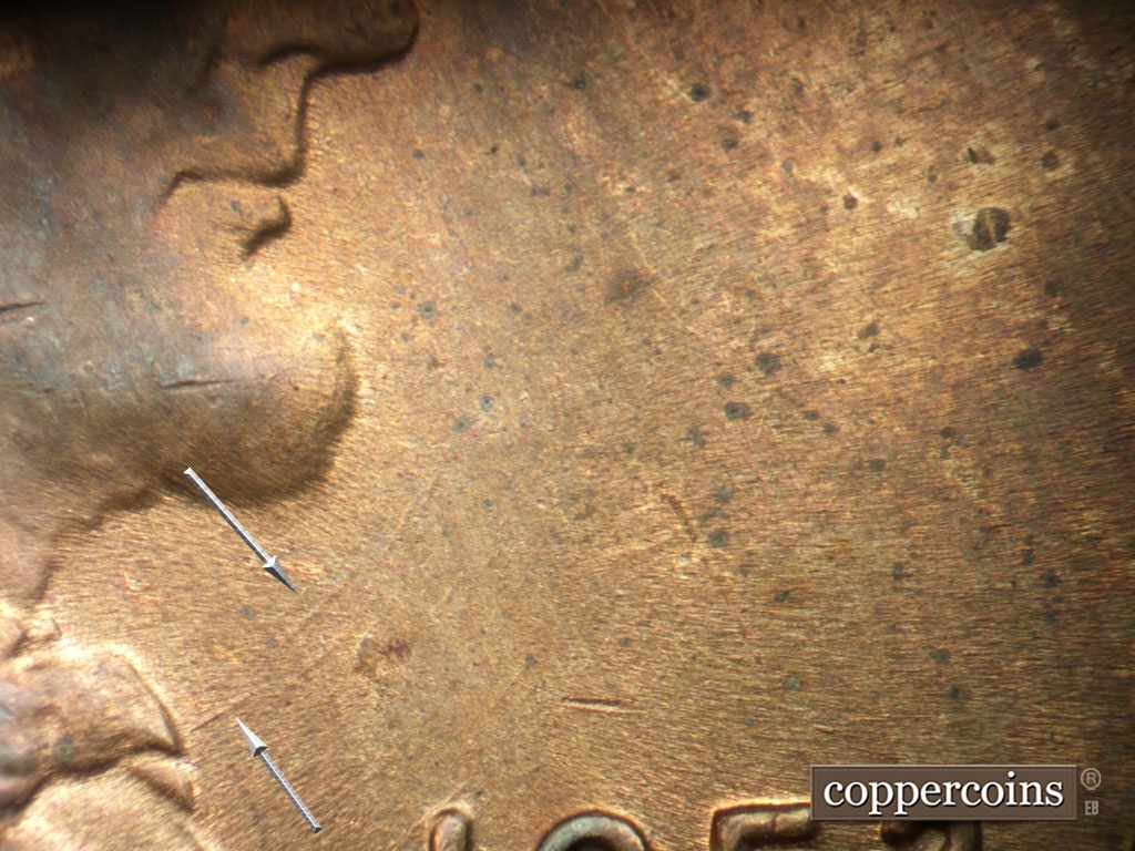 Die-stage C marker on 1952D•1MM•061 showing Concentric die scratches still show from bowtie.