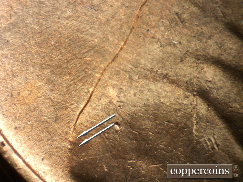 Die-stage C marker on 1952D•1MM•088 showing Die gouges from back of shoulder.