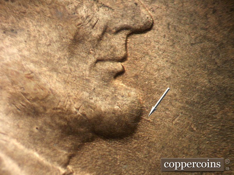 Die-stage C marker on 1952D•1MM•088 showing ESE die scratch from chin.