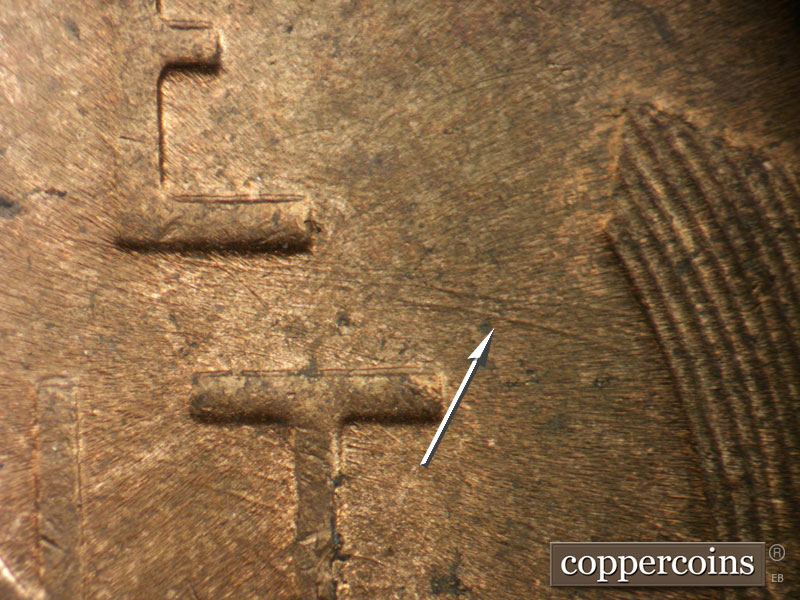 Die-stage C marker on 1952D•1MM•088 showing ESE die scratches from bottom of E in ONE. Die scratches connect bottom of CE in CENT.