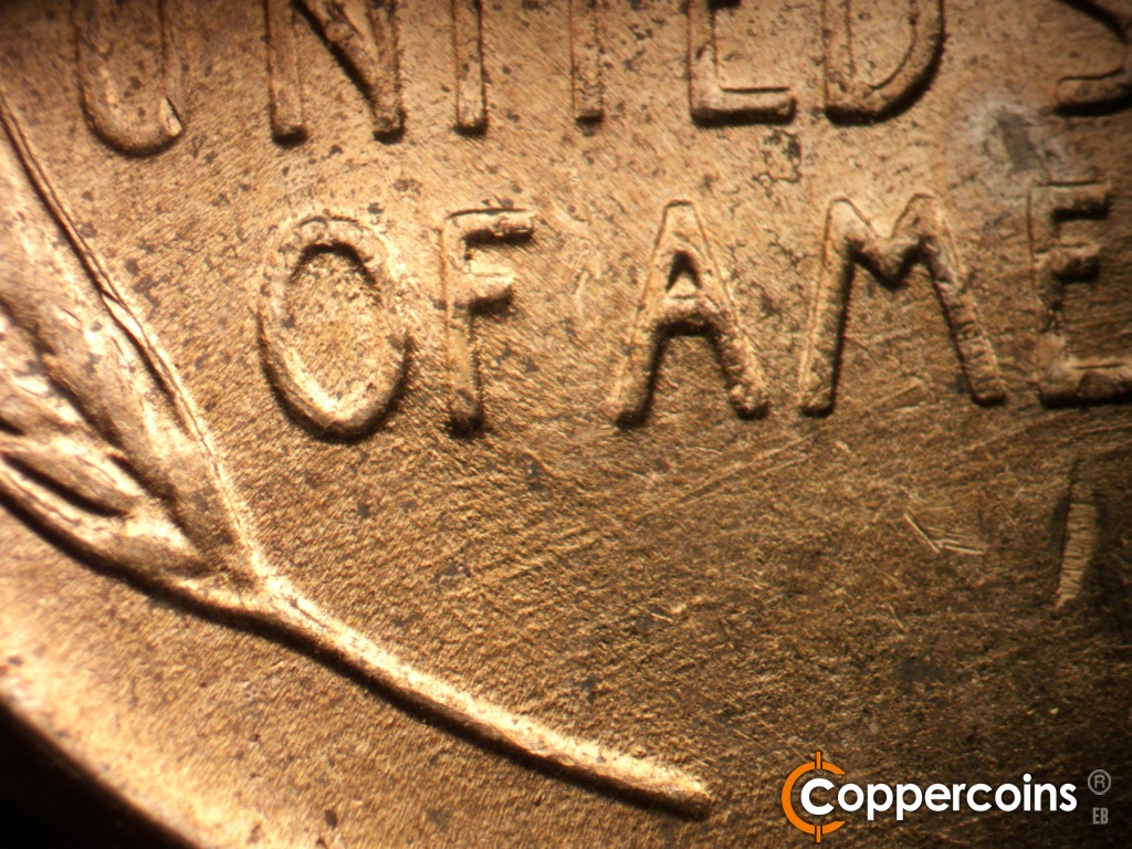 Die-stage B marker on 1952D•1MM•088 showing Die scratches under OF AMERICA.
