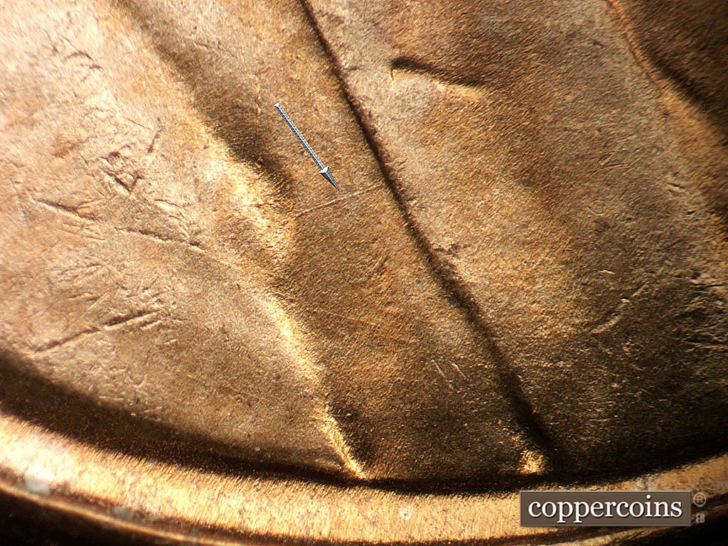 Die-stage B marker on 1952D•1MM•092 showing NE die scratch across jacket.