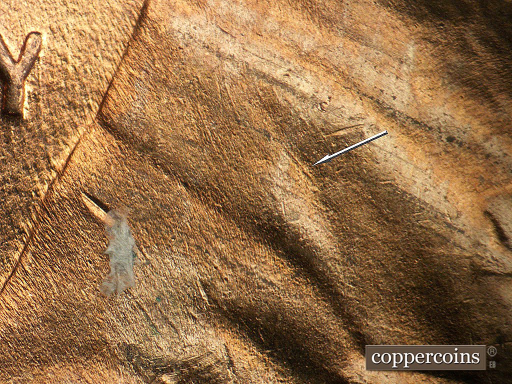 Die-stage B marker on 1952D•1MM•092 showing SE die scratch on collar.