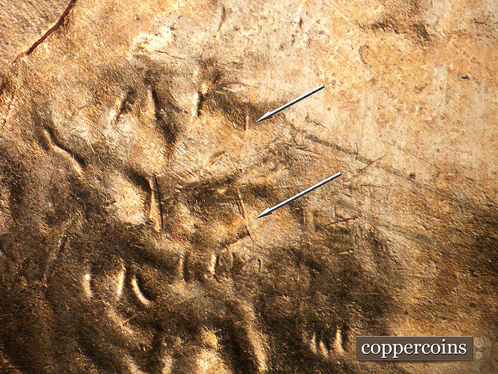 Die-stage B marker on 1952D•1MM•092 showing N/S die crack in hair.
