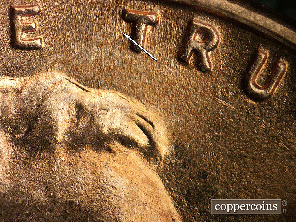 Die-stage B marker on 1952D•1MM•092 showing N/S die scratch near first T in TRUST.