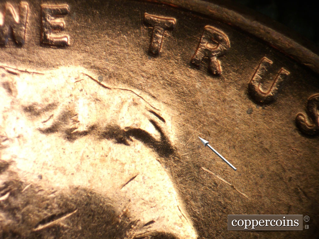 Die-stage A marker on 1952D•1MM•093 showing Light crossing die scratches in front of hair.