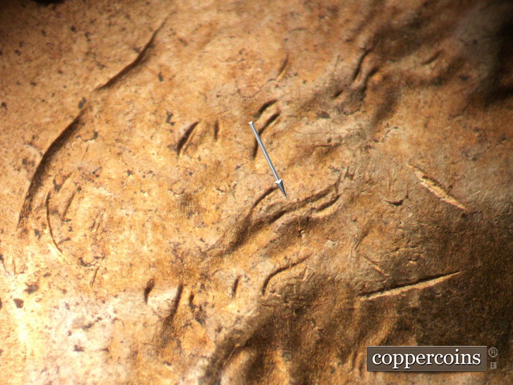 Die-stage B marker on 1952D•1MM•094 showing Die crack in hair.