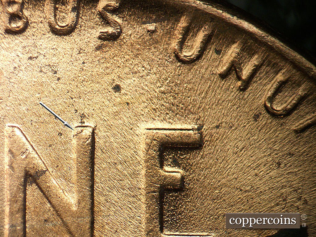 Die-stage C marker on 1952D•1MM•097 showing Small die crack on tip of N in ONE.