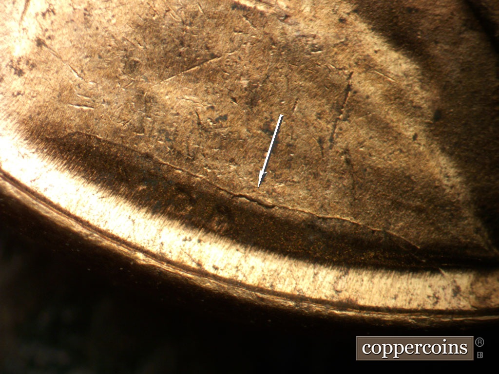 Die-stage B marker on 1952D•1MM•098 showing Die crack above VDB across shoulder.