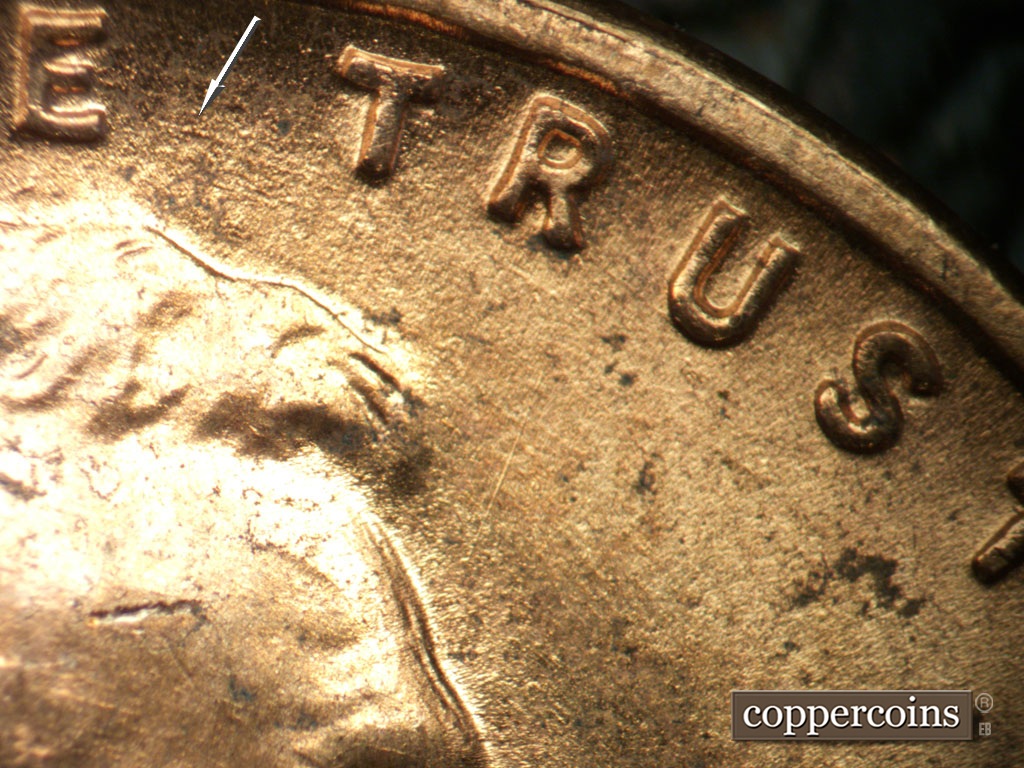 Die-stage B marker on 1952D•1MM•098 showing ESE die scratch between E in WE and first T in Trust.