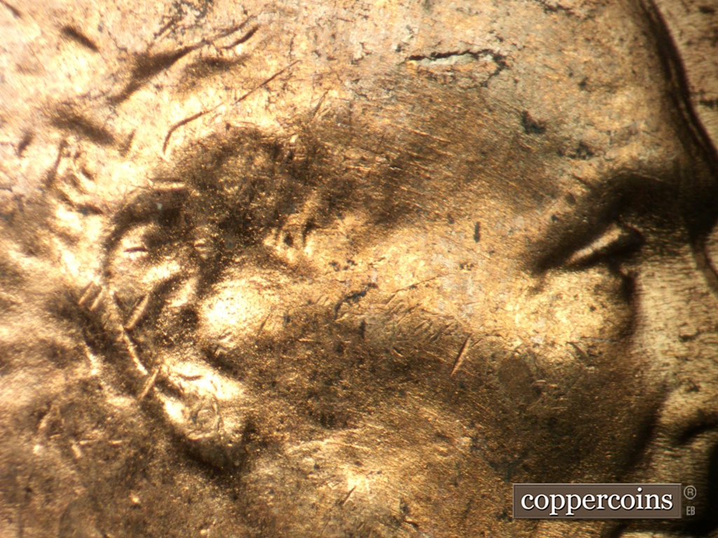 Die-stage B marker on 1952D•1MM•098 showing Concentric die scratches on temple.