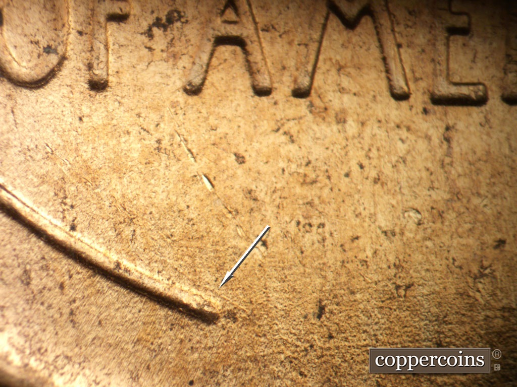 Die-stage B marker on 1952D•1MM•098 showing SE die scratch nextto left wheat stem tip.