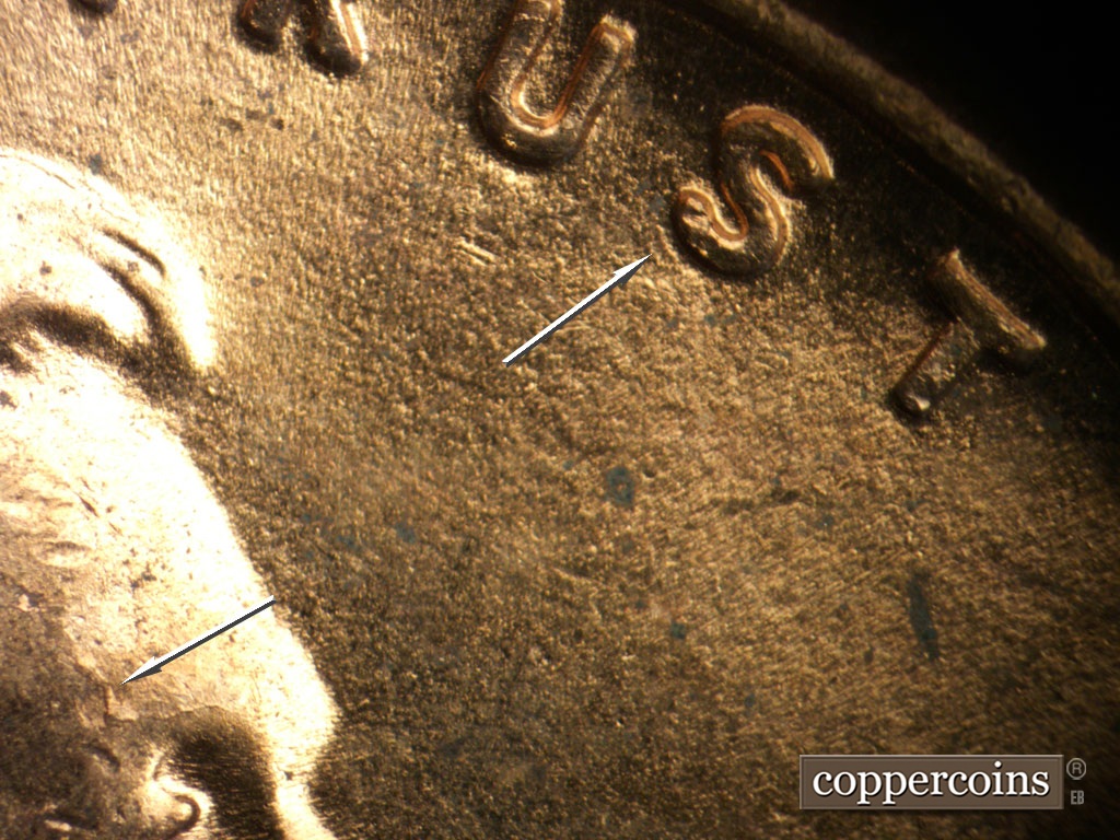 Die-stage C marker on 1952D•1MM•099 showing Small die gouge under S in TRUST. Die crack on eyebrow.
