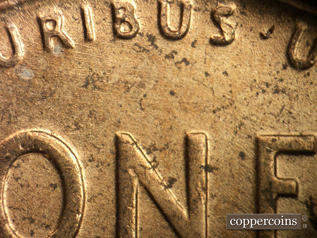 Die-stage B marker on 1952D•1MM•100 showing Light die scratches below PLURIBUS.