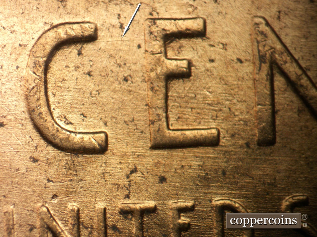 Die-stage B marker on 1952D•1MM•100 showing E/W die scratches through CENT. E/W die scratch connects the top of C to E in CENT.
