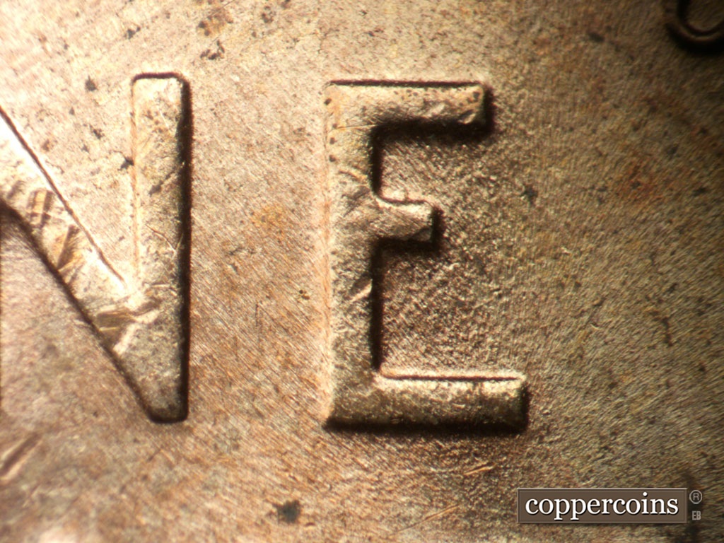 Die-stage B marker on 1953D•1DO•009 showing NE die gouge in lower E in ONE.