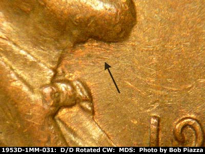Die-stage C marker on 1953D•1MM•031 showing Die scratches under beard.