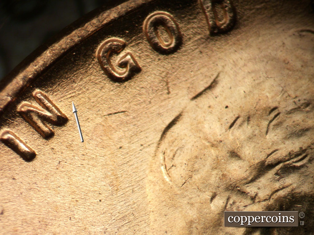 Die-stage B marker on 1953D•1MM•031 showing ENE die scratches from N of IN.