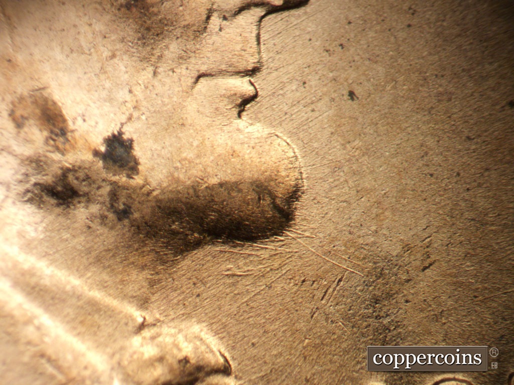 Die-stage B marker on 1953D•1MM•031 showing Heavy die scratches under beard.
