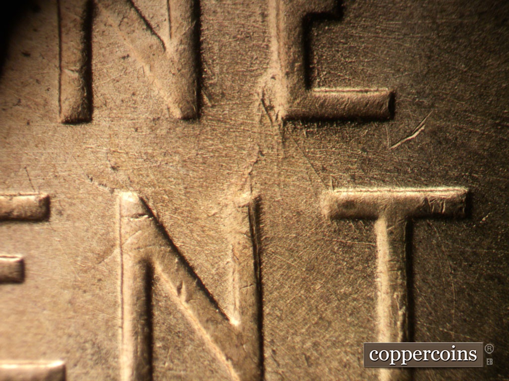 Die-stage B marker on 1953D•1MM•031 showing Heavy gouge or clash on bottom of E in ONE. SE die scratch connects E in ONE to T in TRUST.