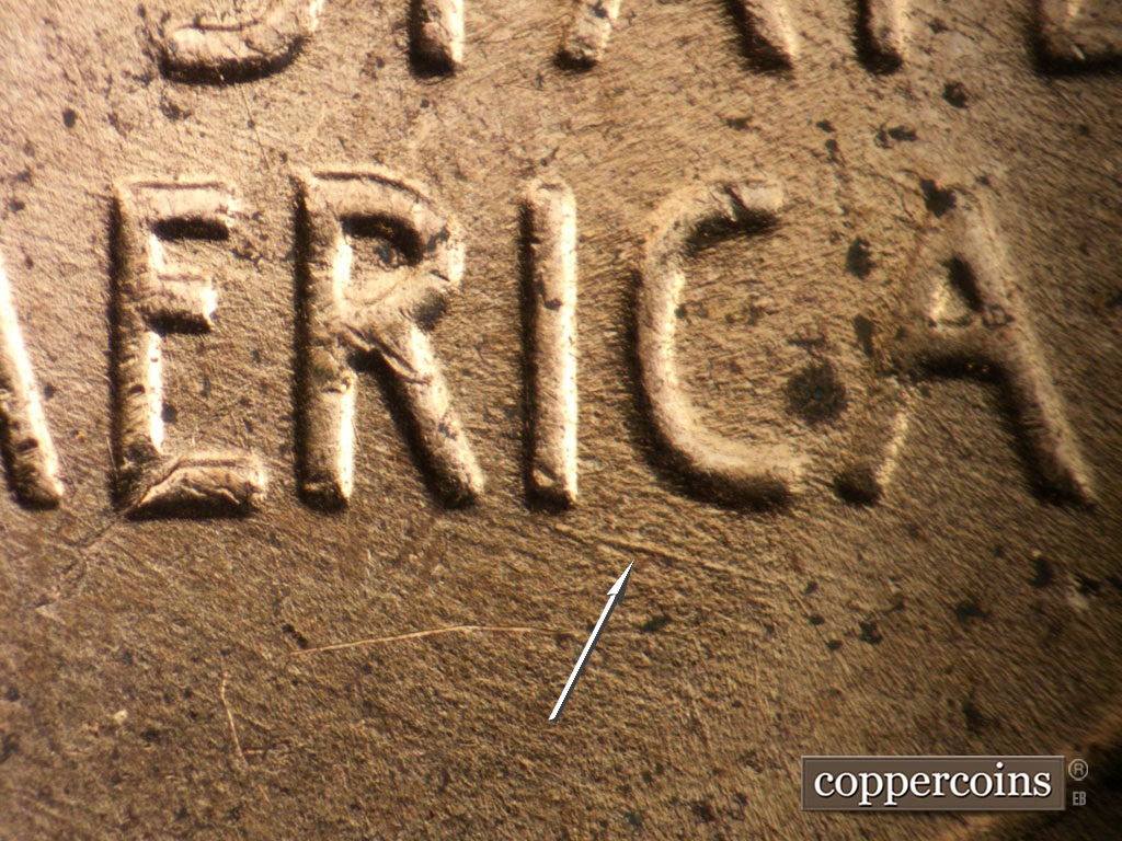 Die-stage B marker on 1953D•1MM•053 showing ESE die scratch from bottom of I in AMERICA.