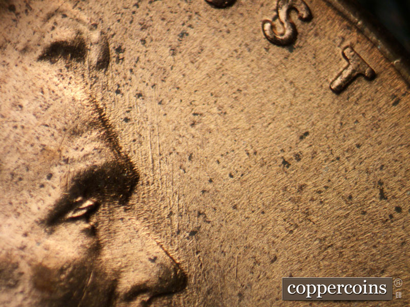 Die-stage C marker on 1953D•1MM•054 showing N/S die scratches from nose.