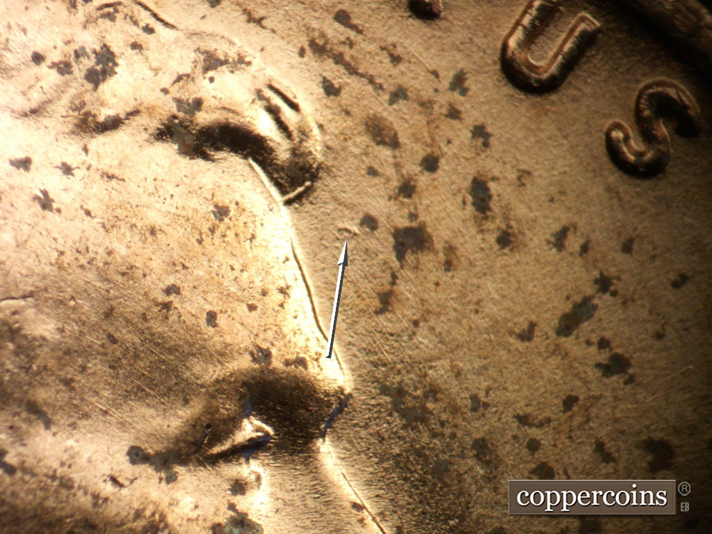 Die-stage B marker on 1953D•1MM•054 showing Die gouge in field in front of forehead.