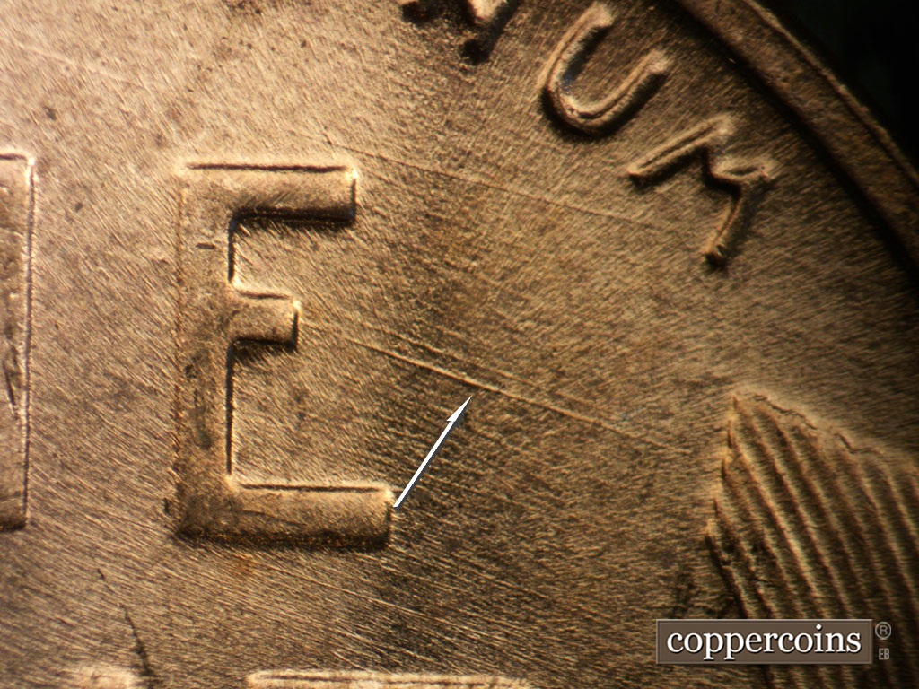 Die-stage B marker on 1953D•1MM•054 showing ESE die scratch from E in ONE.
