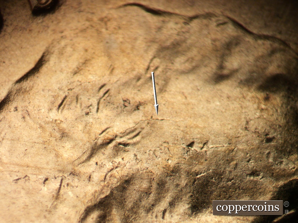 Die-stage B marker on 1953D•1MM•064 showing Die crack from hair into forehead,.