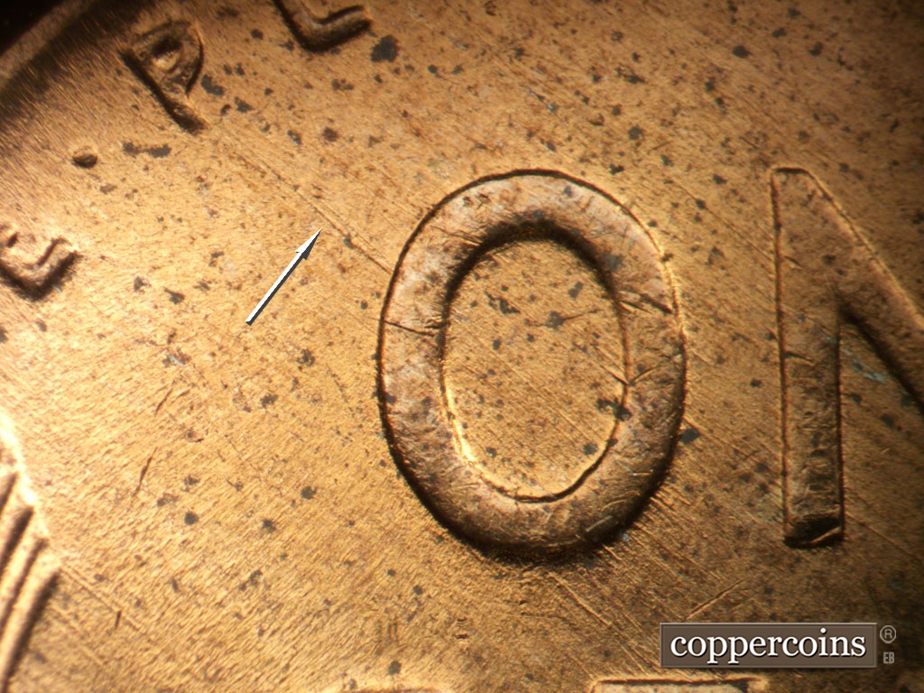 Die-stage B marker on 1953D•1MM•065 showing SE die scratches through O in ONE.
