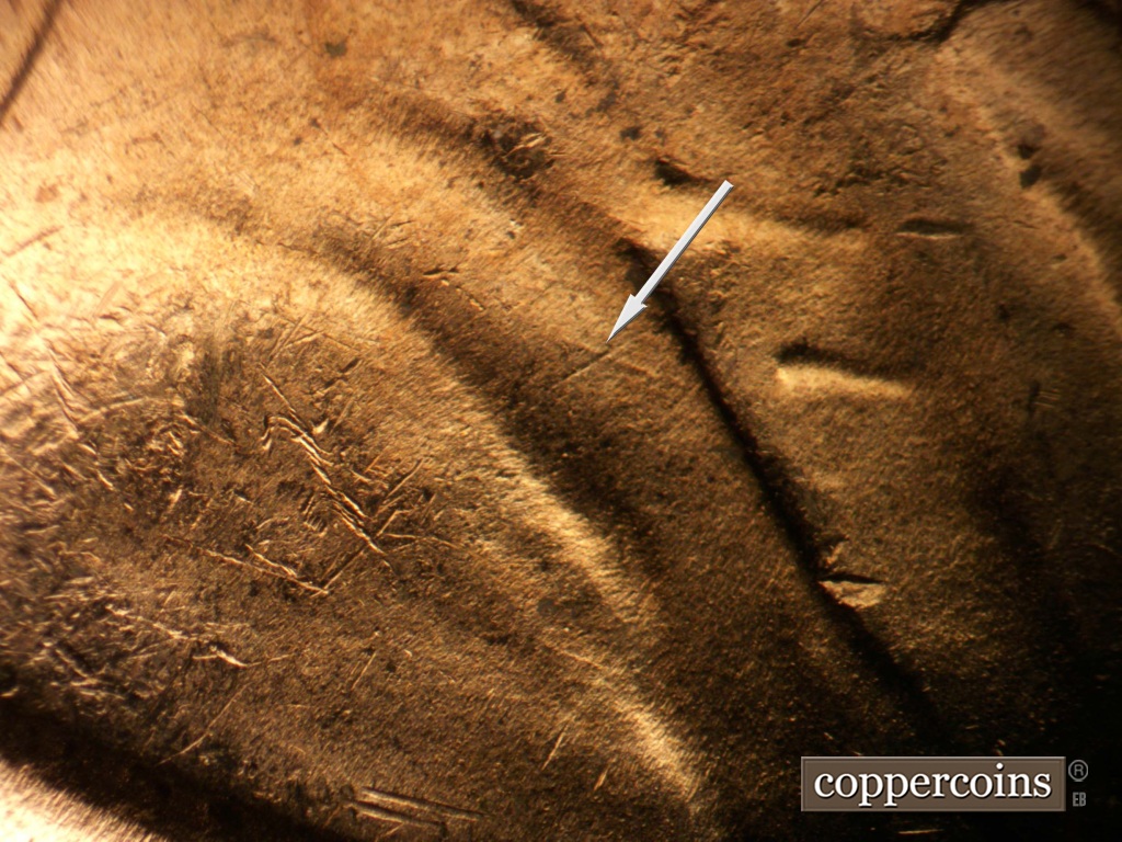 Die-stage B marker on 1953D•1MM•067 showing NW die scratch on jacket.