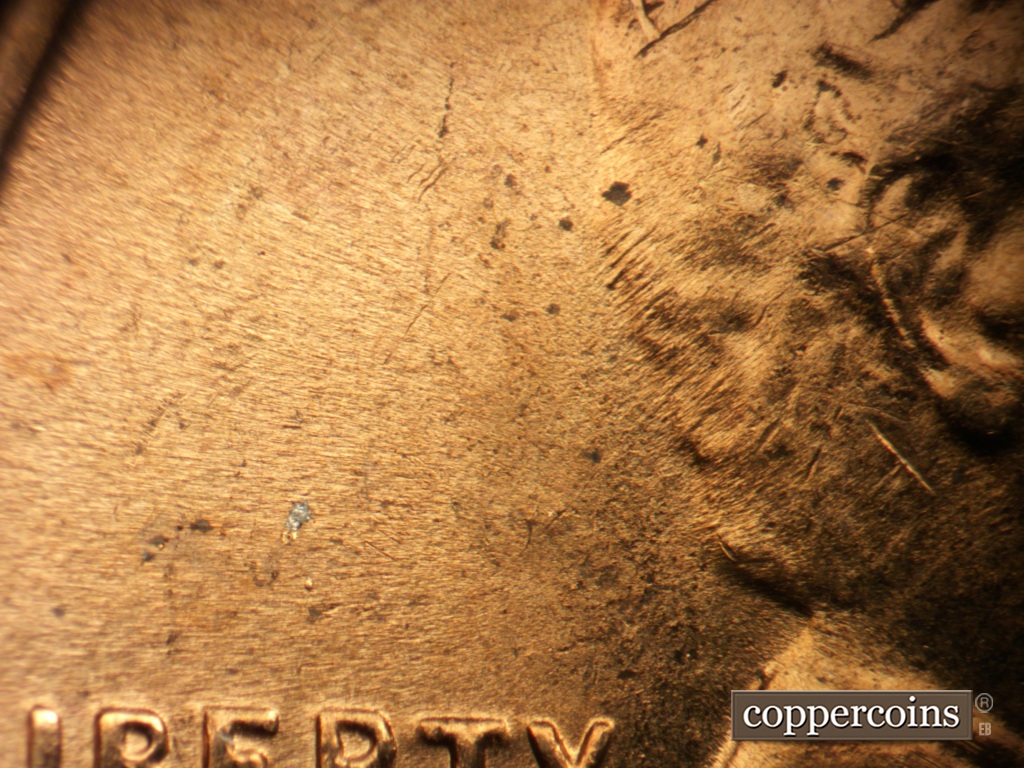 Die-stage B marker on 1953D•1MM•067 showing Short SW die scraches or wear marks from back of hair.