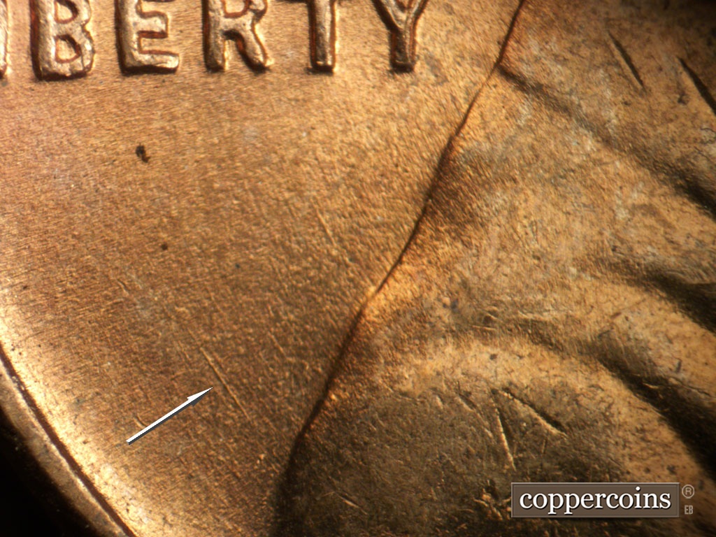Die-stage A marker on 1953P•1DO•003 showing Concentric die scratch from back of shoulder toward LIBERTY.