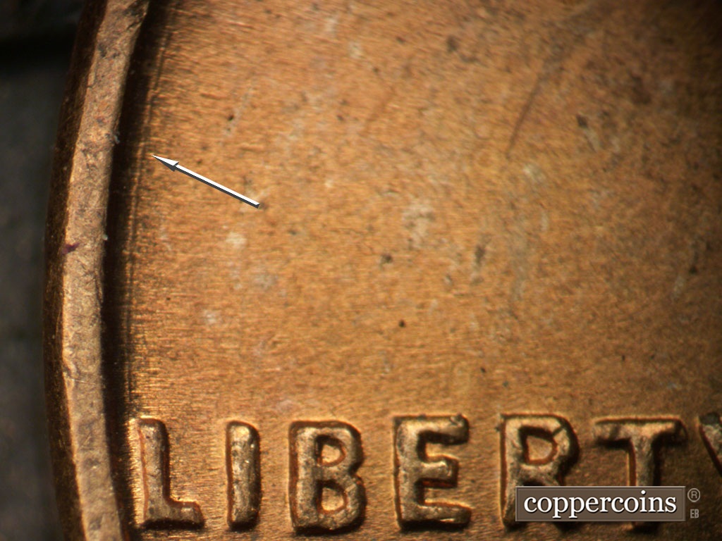 Die-stage A marker on 1953P•1DO•003 showing Concentric die scratch from L in LIBERTY near rim.