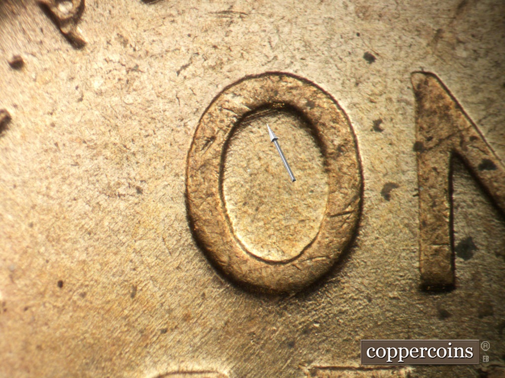 Die-stage A marker on 1953P•1DO•003 showing ENE die scratches inside top O in ONE.