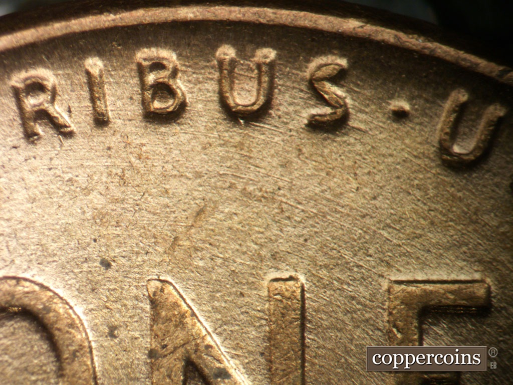 Die-stage A marker on 1953P•1DO•003 showing Concentric die scratches through PLURIBUS.