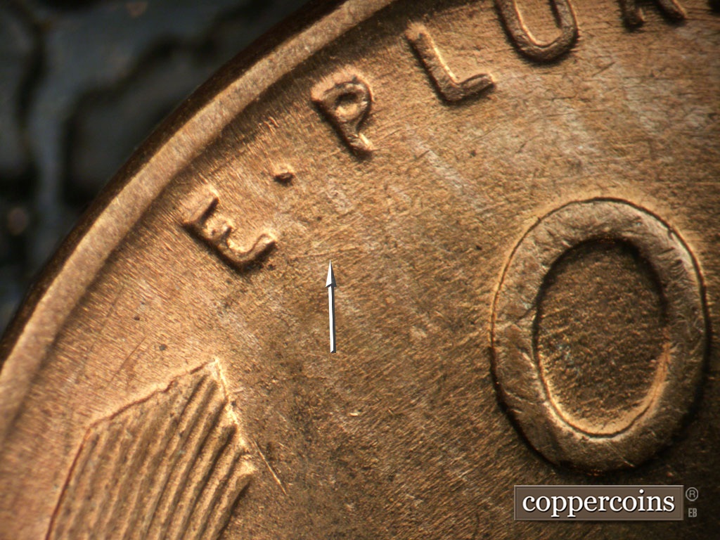 Die-stage B marker on 1953P•1DO•004 showing E/W die scratch from bottom of E in E PLURIBUS UNUM.