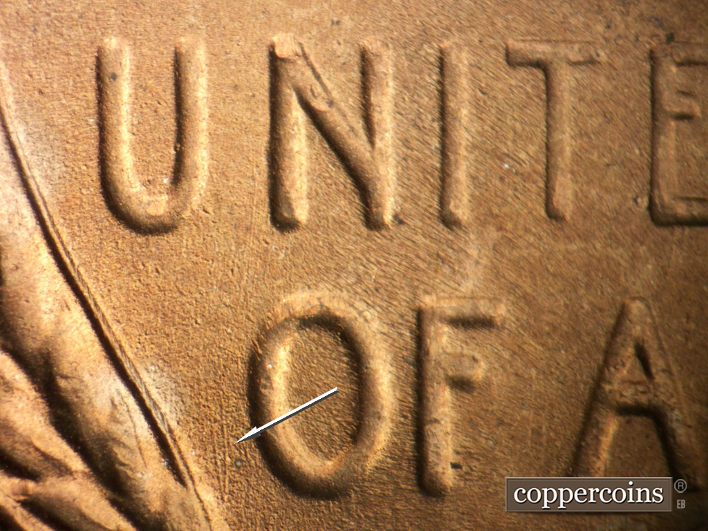 Die-stage B marker on 1953S•1MM•049 showing N/S die scratches beside O in OF.