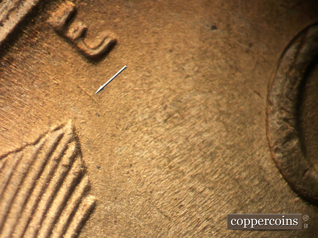 Die-stage B marker on 1953S•1MM•050 showing NW die scratch between E and left wheat stalk tip.