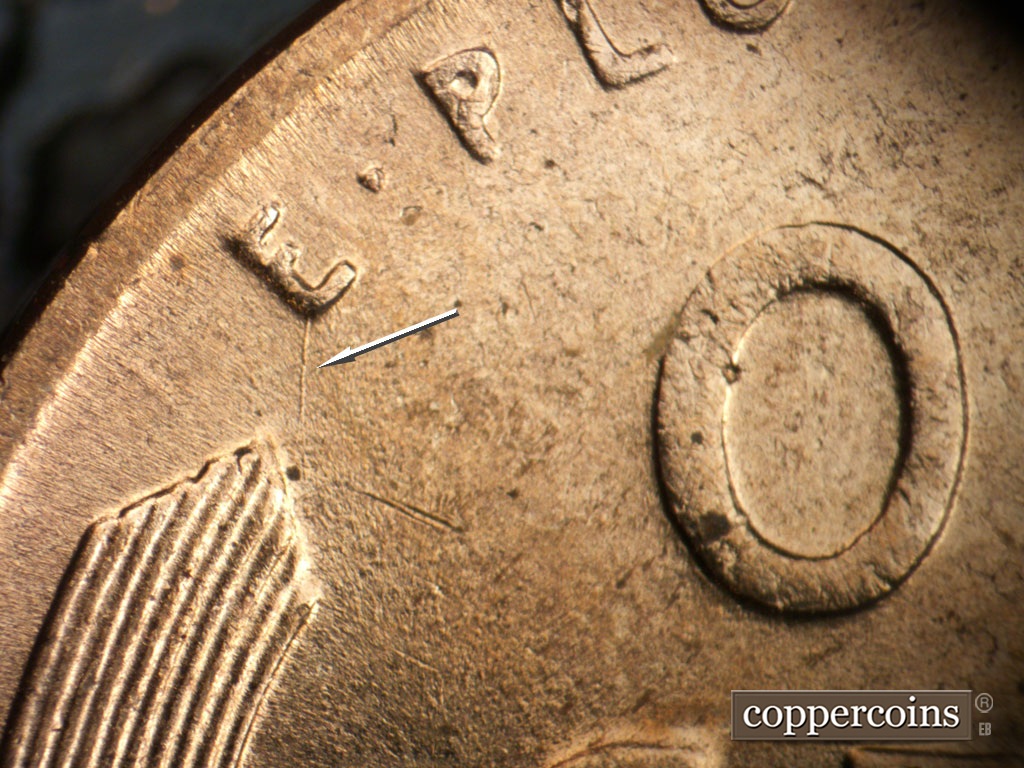 Die-stage B marker on 1954D•1MM•046 showing N/S die scratch from E in E PLURIBUS UNUM.