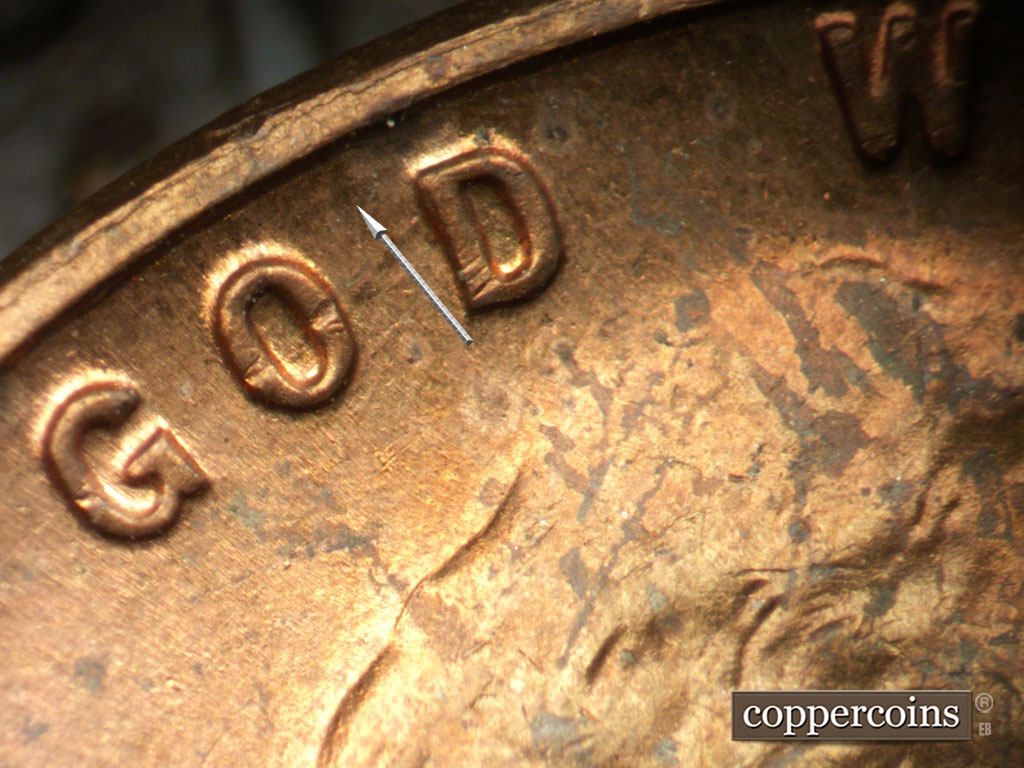 Die-stage C marker on 1954P•1DO•001 showing Concentric die scratch is almost totally worn away.